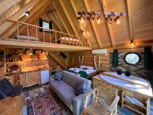 a living room with a large tub in a cabin at Moon River Bungalow in Ayder Yaylasi