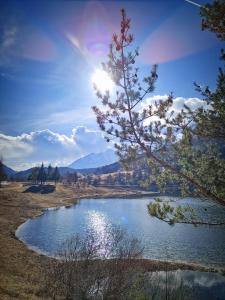 a view of a river with the sun in the sky at Appartamenti La Val in Andalo