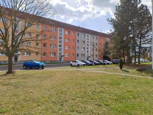 a parking lot with cars parked in front of a building at BurgK59, 3 BR, 6 Beds, TV, Kitchen and Bath in Muldenstein