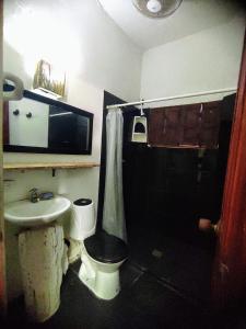 a bathroom with a toilet and a sink at La Caracola Cartagena in Cartagena de Indias