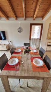 a wooden table with plates and glasses on it at Dai cugini del Garda in Salò