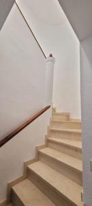 a staircase in a house with a white wall at Casa la perla de sefarad in Lucena +10 photos