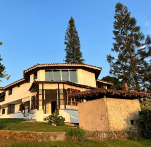 een groot huis met een boom ervoor bij Finca Calimita in Calima