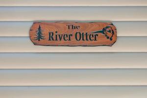 a sign that says the river otter on a wall at River Otter Hot Tub BBQ Fire Pit Russian River Gem in Rio Nido +30 photos