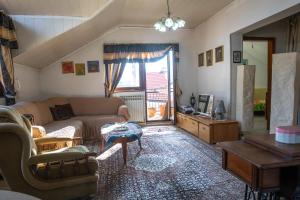 een woonkamer met een bank en een tafel bij Guest House Fena in Sarajevo