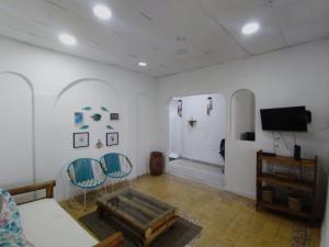 a living room with two chairs and a tv at Casa Carla Cartagena Hospedaje Céntrico y Familiar in Cartagena de Indias