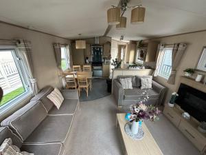 an aerial view of a living room with a couch and a table at Sunset Paradise in Selsey