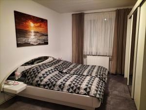 a bedroom with a bed and a picture on the wall at Pension Rosenvilla in Sedlitz