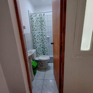 a bathroom with a toilet and a shower curtain at El Capricho II Paracas in Paracas +28 photos