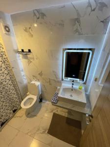 y baño con lavabo, aseo y espejo. en Expérience de luxe ultime / Parking / Restaurant / Cafe / Carrefour, en Oujda