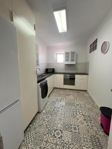 a kitchen with a tile floor and a refrigerator at Buena Vista, Cehegin in Cehegín