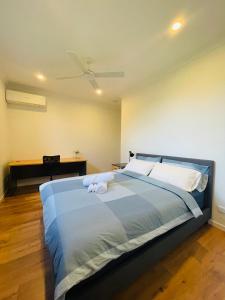 a bedroom with a large blue bed with a ceiling at Modern Private Room 1,2 close to QEII & Grifith Uni in Brisbane