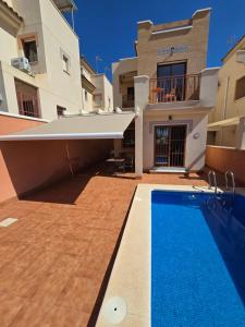 a swimming pool in the backyard of a house at Duplex 6 Mar de Plata in Puerto de Mazarrón