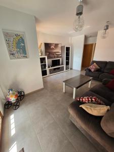 a living room with a couch and a table at Duplex 6 Mar de Plata in Puerto de Mazarrón