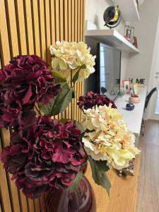 wazon wypełniony kolorowymi kwiatami na stole w obiekcie Horta's home w Tiranie