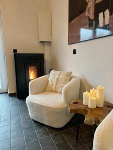 uma sala de estar com um sofá e uma mesa com velas em La Maisonnette em Theux
