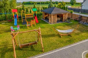 an aerial view of a playground with chairs and a house at Ahoi Jantar Domki Premium in Jantar