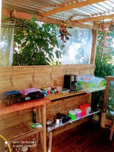 an outdoor kitchen with a table with food and drinks at Eco Camping Aventura Salento in Salento