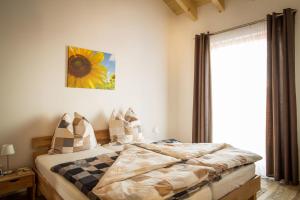 ein Schlafzimmer mit einem Bett und einem großen Fenster in der Unterkunft Ferienwohnung Dormettinger Lindenhof in Dormettingen