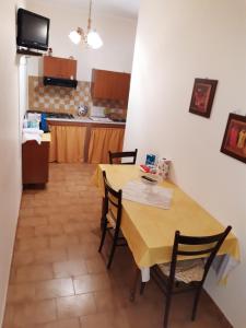 a kitchen with a table and chairs in a room at La casa di Lina in Milena