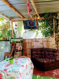 a patio with a table and a chair and a tv at Eco Camping Aventura Salento in Salento