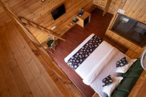 an overhead view of a bed in a wooden room at Bayview Resort in Anjuna