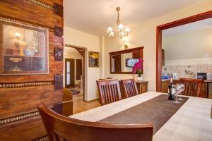 a dining room with a table and some chairs at Apartament Czarny Potok Lux Zakopane in Zakopane