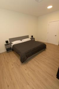 een slaapkamer met een groot bed en 2 nachtkastjes bij Spacious 3-BR Luxury Suite near New York City in Union City