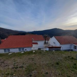 a view of two houses with red roofs at Casas da Escola - "Casa da Professora" - Meãs in Pampilhosa da Serra