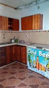 a kitchen with a cold beer sign on the counter at El Capricho II Paracas in Paracas