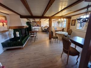 a living room with a fireplace and a table and chairs at LilaLila Lodge in Magdenau