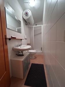 a bathroom with a white sink and a toilet at La Casetta in Moneglia