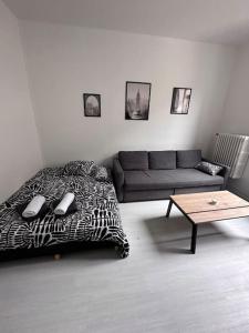 a living room with a bed and a couch at L’insolite in Auxerre