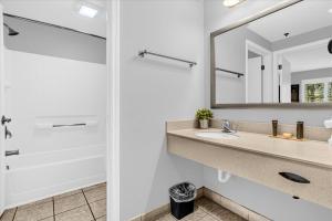 a bathroom with a sink and a mirror at Condo Near Universal Studios With Pool Hot Tub in Orlando