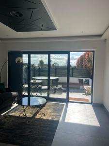 a living room with a view of a patio at Fox Lodge in Norwich