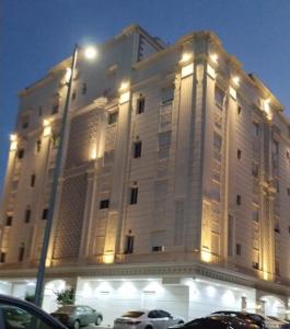 a large white building with cars parked in front of it at استديو حي النزهه in Jeddah
