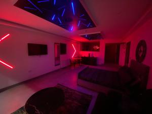 a living room with red and blue lights on the ceiling at Fox Lodge in Norwich