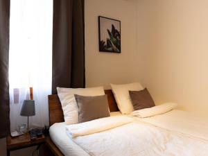 a bedroom with a bed with white sheets and pillows at Golubina 3 - Soba sa Sopstvenim Kupatilom in Golubac
