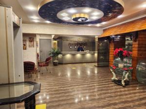 a lobby with a ceiling with a large room with a lobby at Oasis Hotel Heliopolis in Cairo