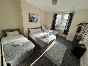 a small bedroom with two beds and a couch at AA Gateshead in Gateshead