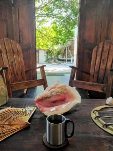 a table with a bagel and a cup on it at La Caracola Cartagena in Cartagena de Indias