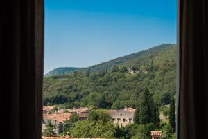 a view from a window of a town and a mountain at La Bastia - Bed & Soul in Nuvolento