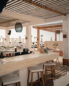 a kitchen with a wooden counter and stools at Le Sidi Cabana ( hacienda bay ) in El Alamein