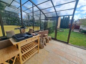 a greenhouse in a garden with a table and chairs at Family house with garden and sauna in Trnávka