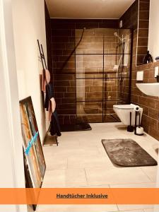 a bathroom with a shower and a toilet at Better Living - Villa - Exklusiv Studio 76qm in Montabaur