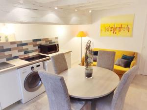 a kitchen and dining room with a table and chairs at Cosy Claudel in Nogent-sur-Seine