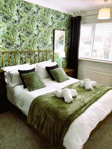 a bedroom with a large bed with two pillows on it at COLE HOUSE in Solihull