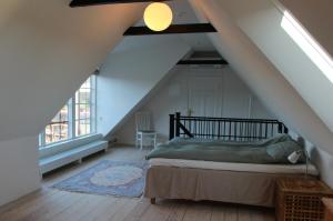 a bedroom with a bed in a attic at Bjerred B&B in Bjärred