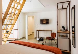 a bedroom with a bed and a ladder and a desk at Case Varanni Etna Experience in Viagrande