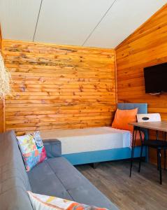 Zimmer mit einem Bett in einer Holzwand in der Unterkunft Adrasan Yıldız Bungalow Tatil Köyü in Adrasan